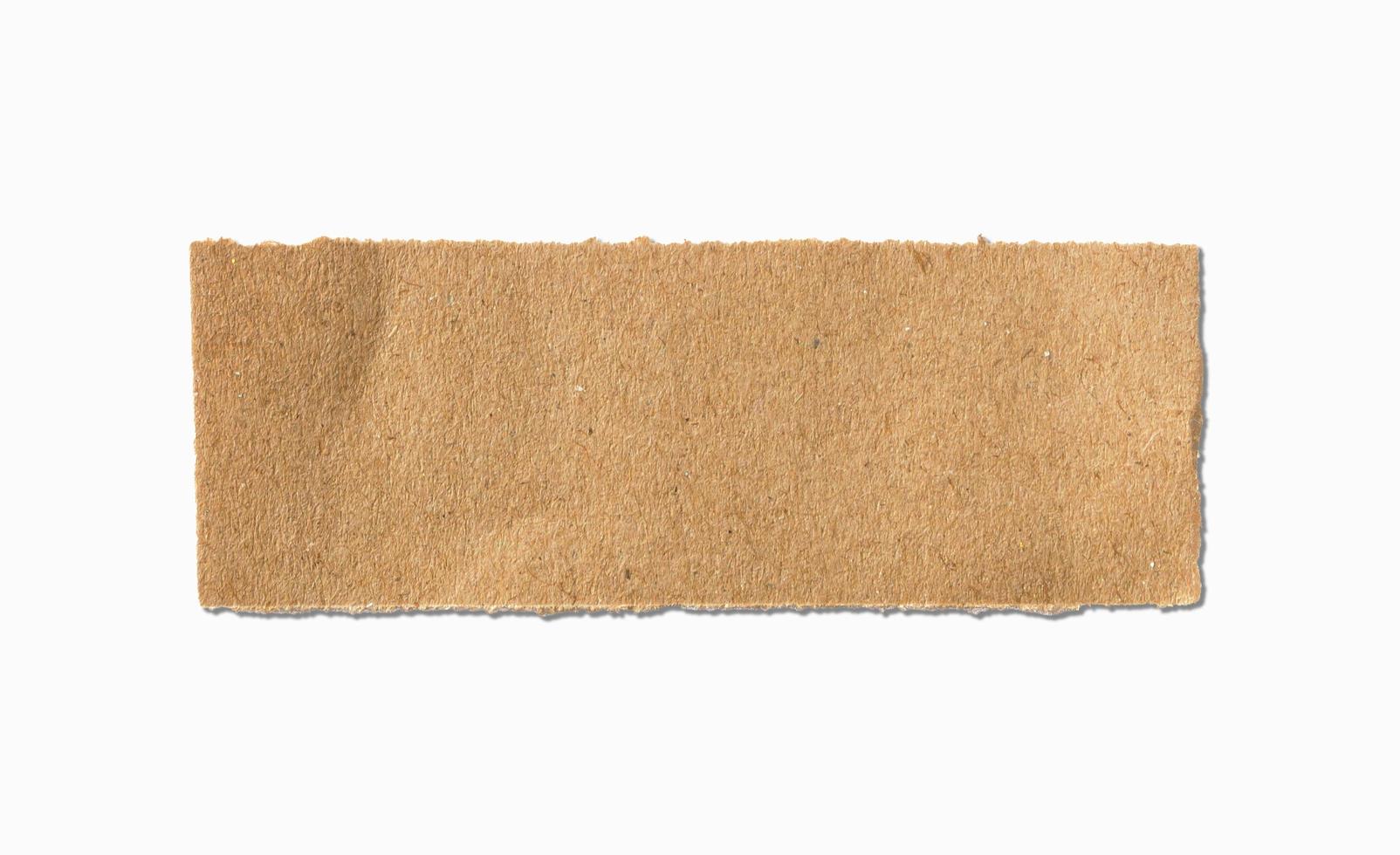 Torn brown paper sheet on white background photo