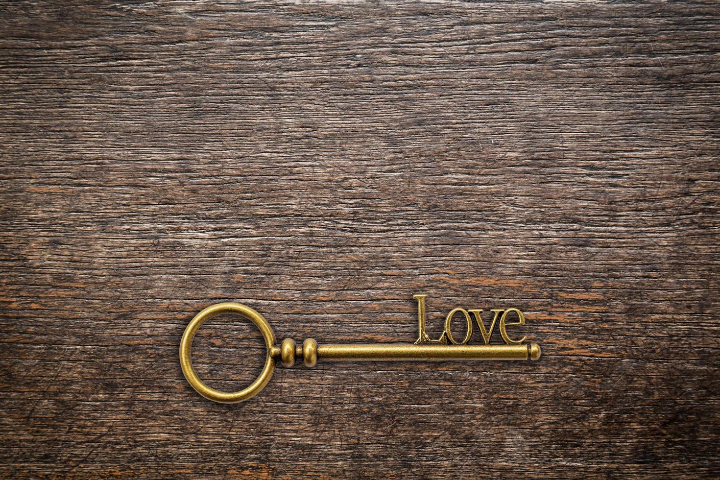 Vintage key for love on wood background with space. Valentine background. photo