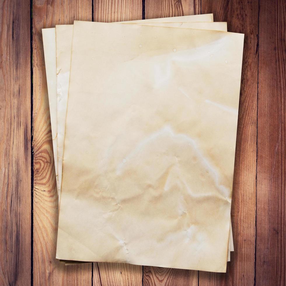 old paper on wood background and texture with space. photo