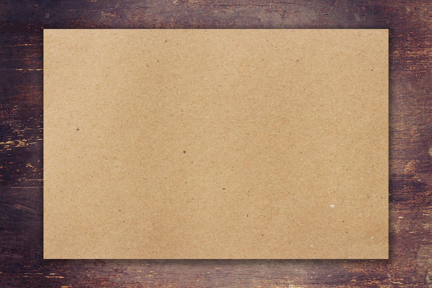 brown paper on wood background with space photo