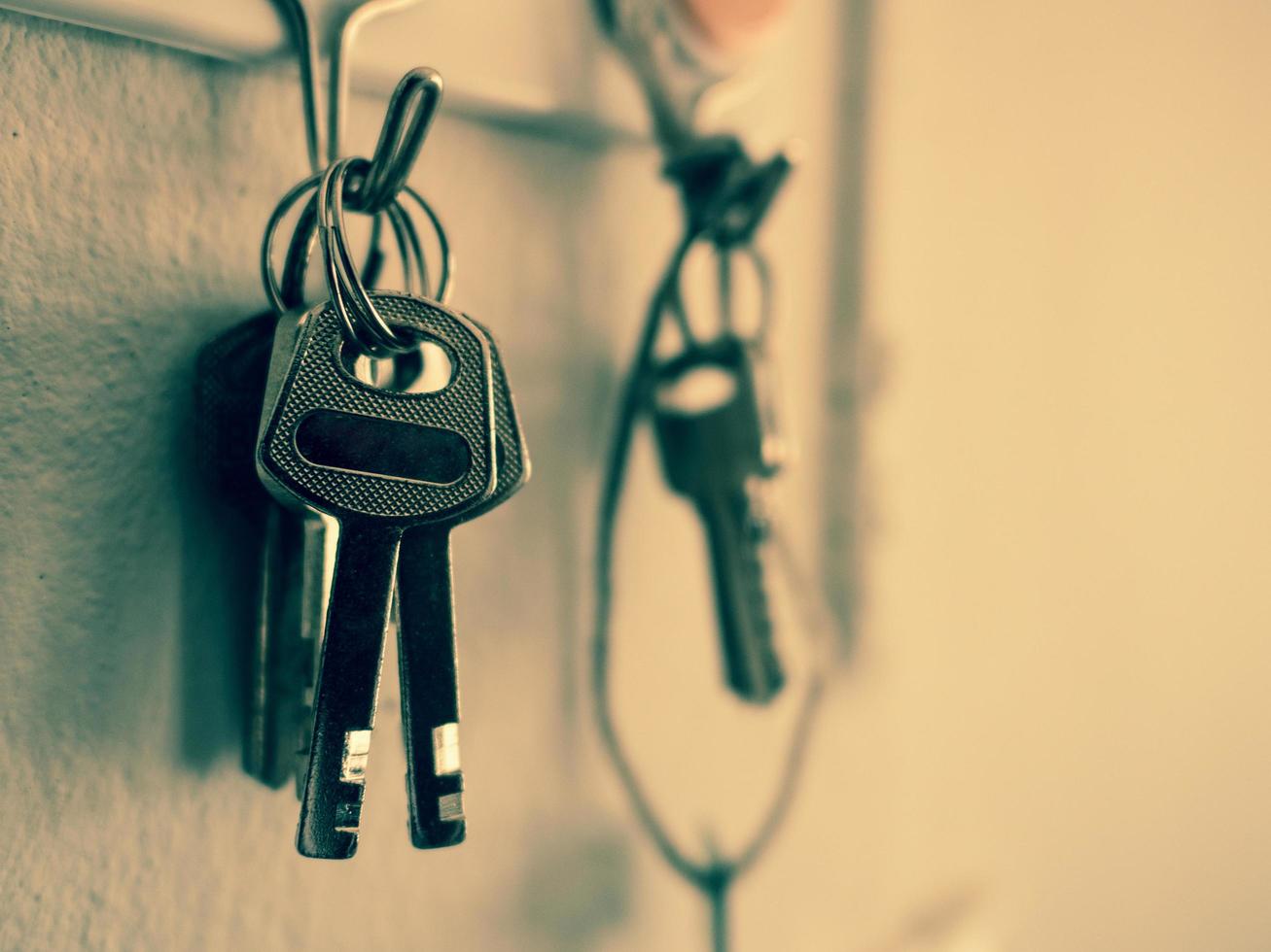 old key vintage hanging on cement wall background photo