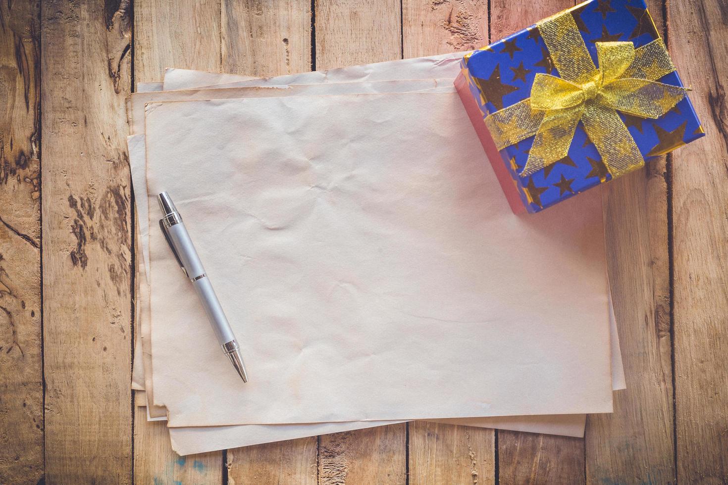 old paper and gift box with pen for vintage background photo