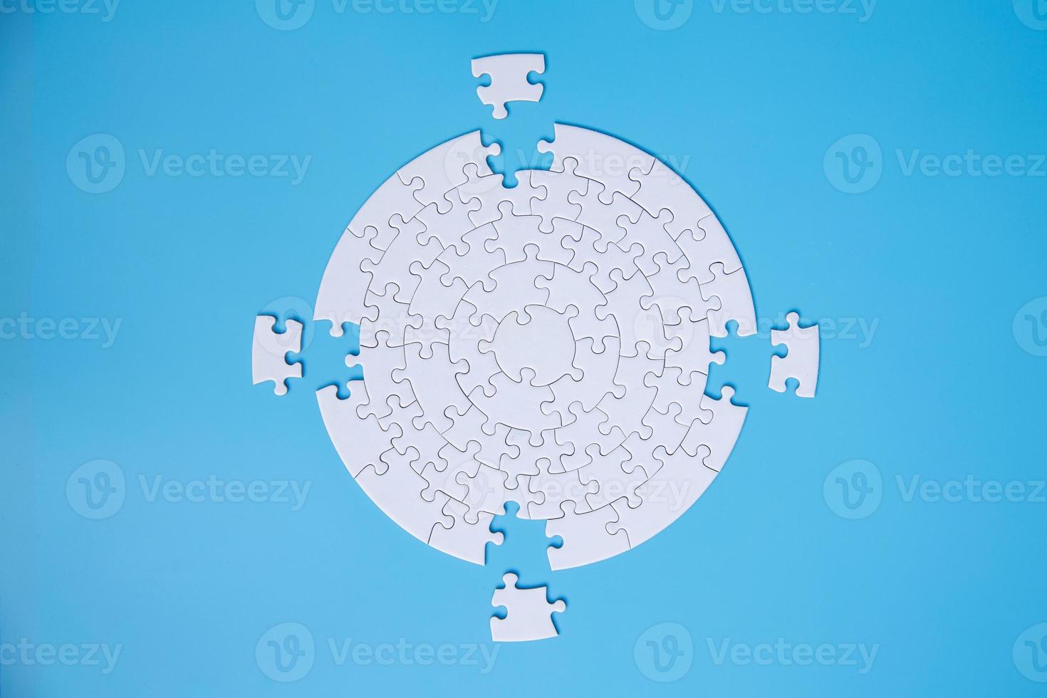 White jigsaw puzzle pieces on a blue background. Problem solving concepts. Texture photo with copy space for text