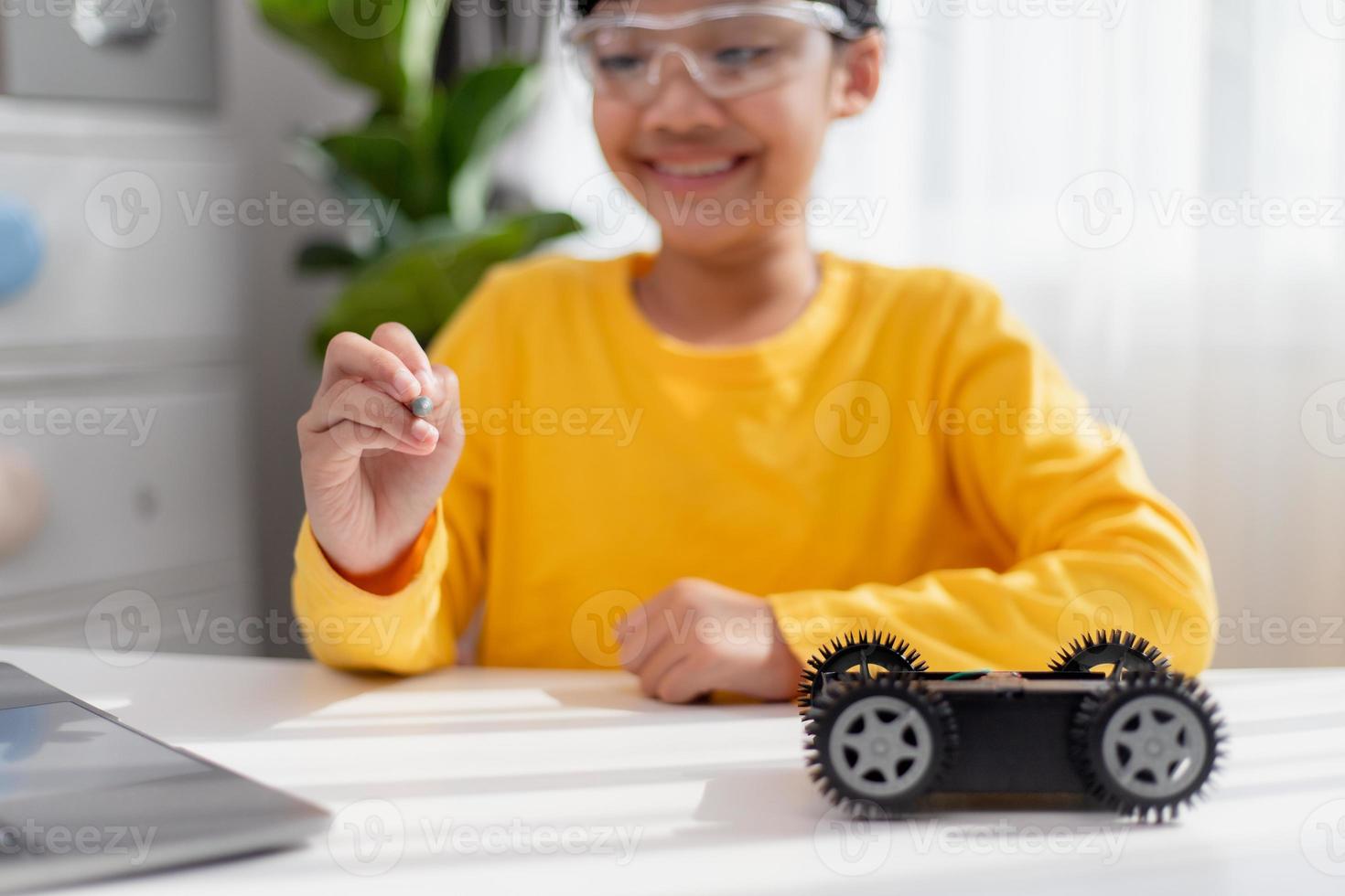 Asia students learn at home in coding robot cars and electronic board cables in STEM, STEAM, mathematics engineering science technology computer code in robotics for kids concept. photo