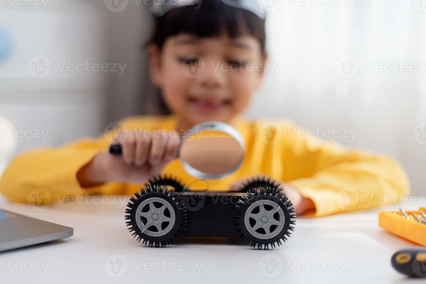 Asia students learn at home in coding robot cars and electronic board cables in STEM, STEAM, mathematics engineering science technology computer code in robotics for kids concept. photo