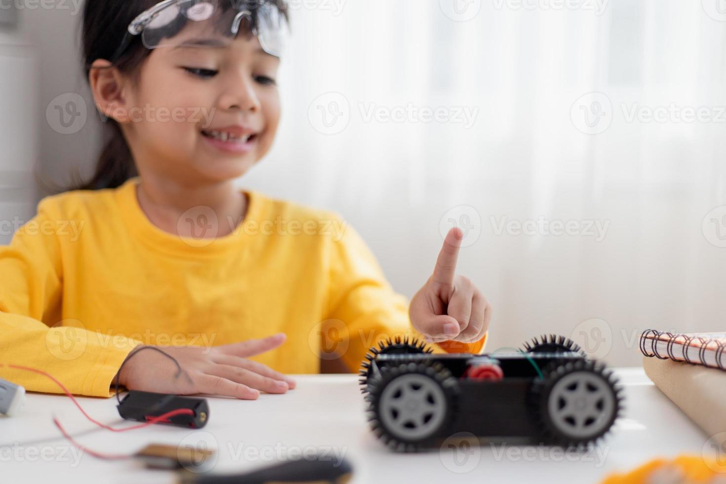 Asia students learn at home in coding robot cars and electronic board cables in STEM, STEAM, mathematics engineering science technology computer code in robotics for kids concept. photo