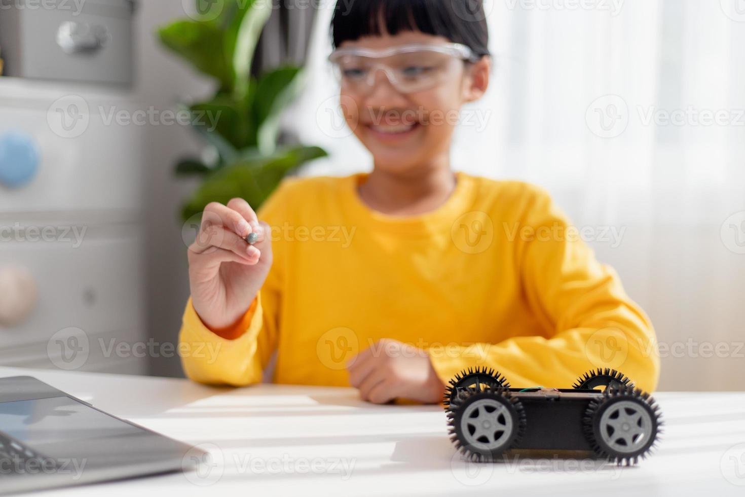 Asia students learn at home in coding robot cars and electronic board cables in STEM, STEAM, mathematics engineering science technology computer code in robotics for kids concept. photo
