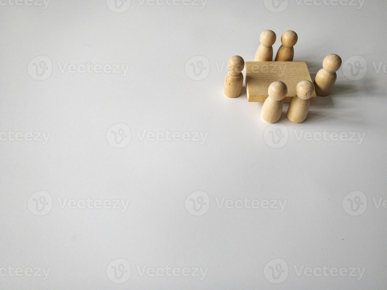 Wooden people figures having business meeting with customizable space for text. Copy space. photo