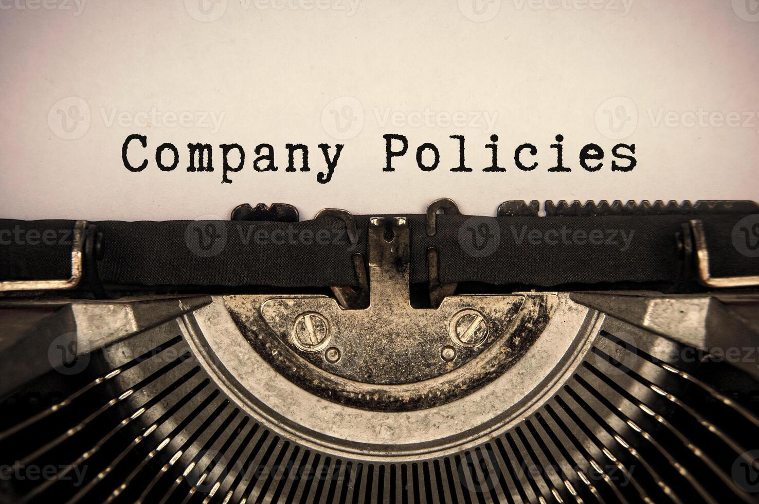 Company policies text typed on an old vintage typewriter. Company policy concept. photo