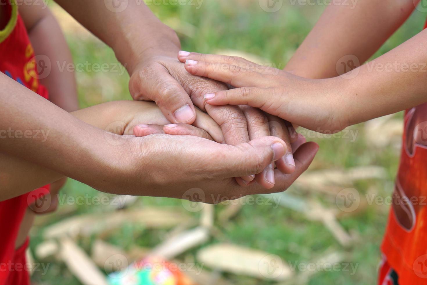 The hands of a child and a mother join forces. photo