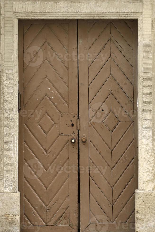 Old ancient wooden door texture in european medieval style photo