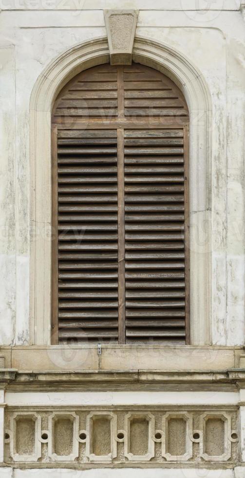 Texture of aged wooden window of ancient medieval building photo