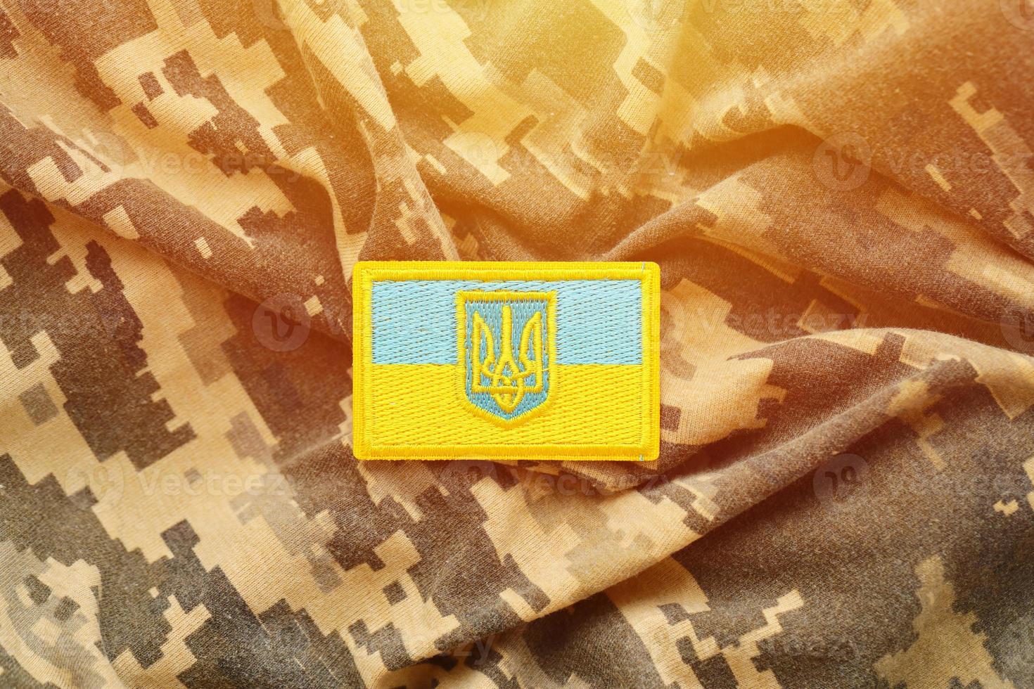 Military camouflage fabric with ukrainian flag on uniform chevron photo