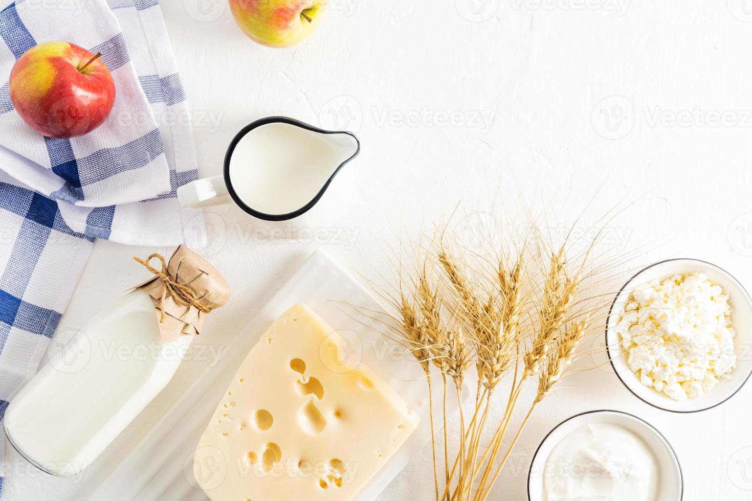 Jewish holiday Shavuot concept with dairy products, fruits, cheese, milk bottle on white table. Flat lay, top view. photo