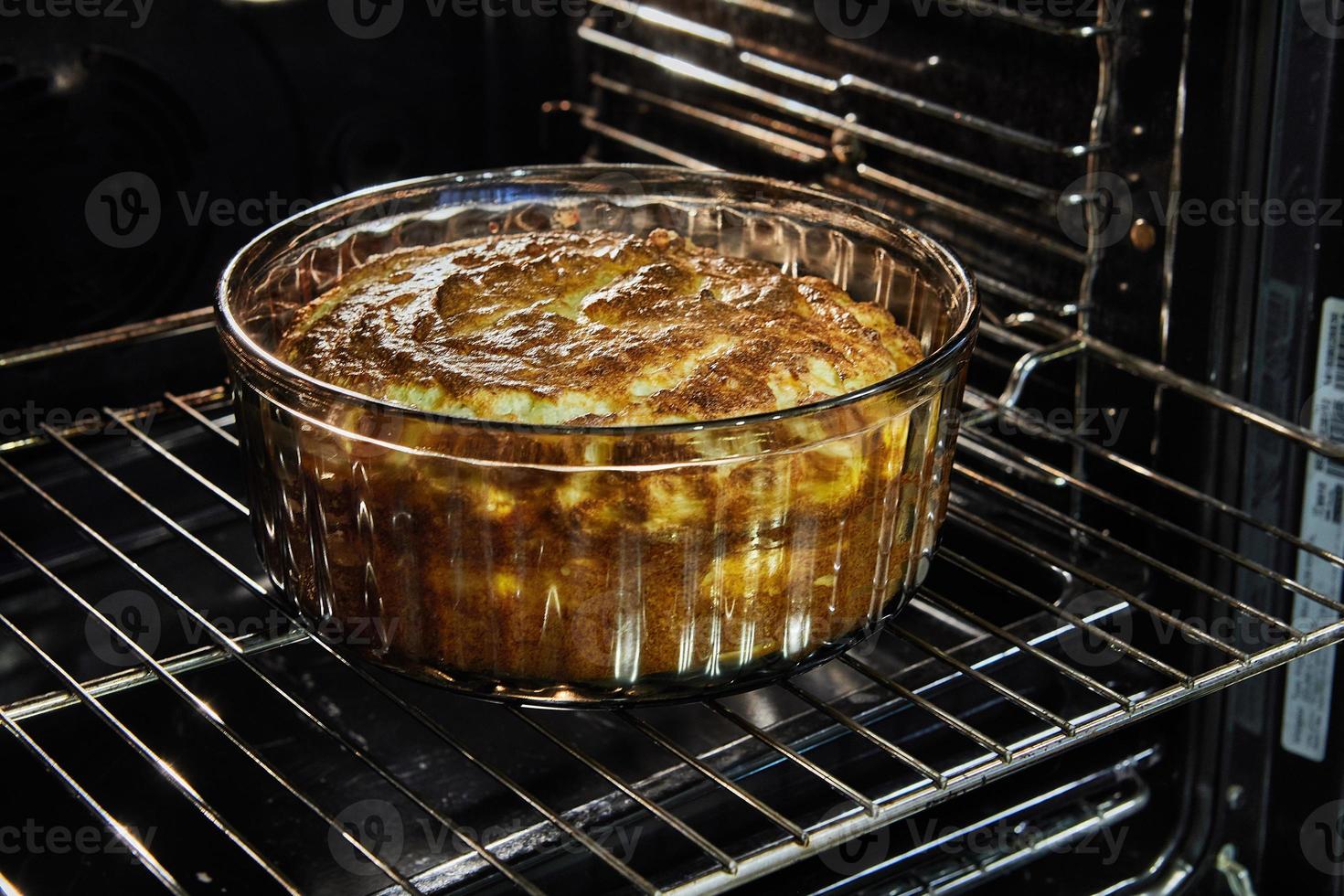 Cauliflower souffle in a transparent bowl in the oven after baking photo