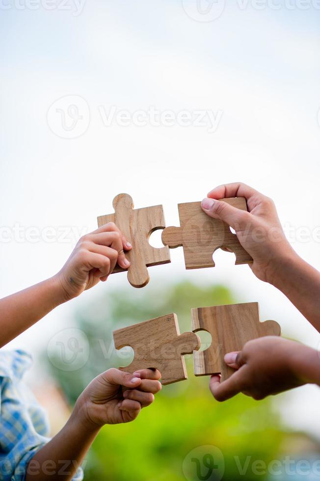 jigsaw and hands Combine the power of unity, teamwork, teamwork. photo