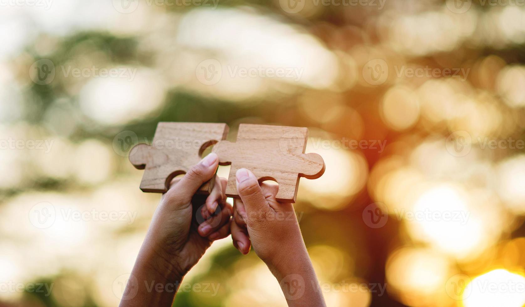 jigsaw and hands Combine the power of unity, teamwork, teamwork. photo