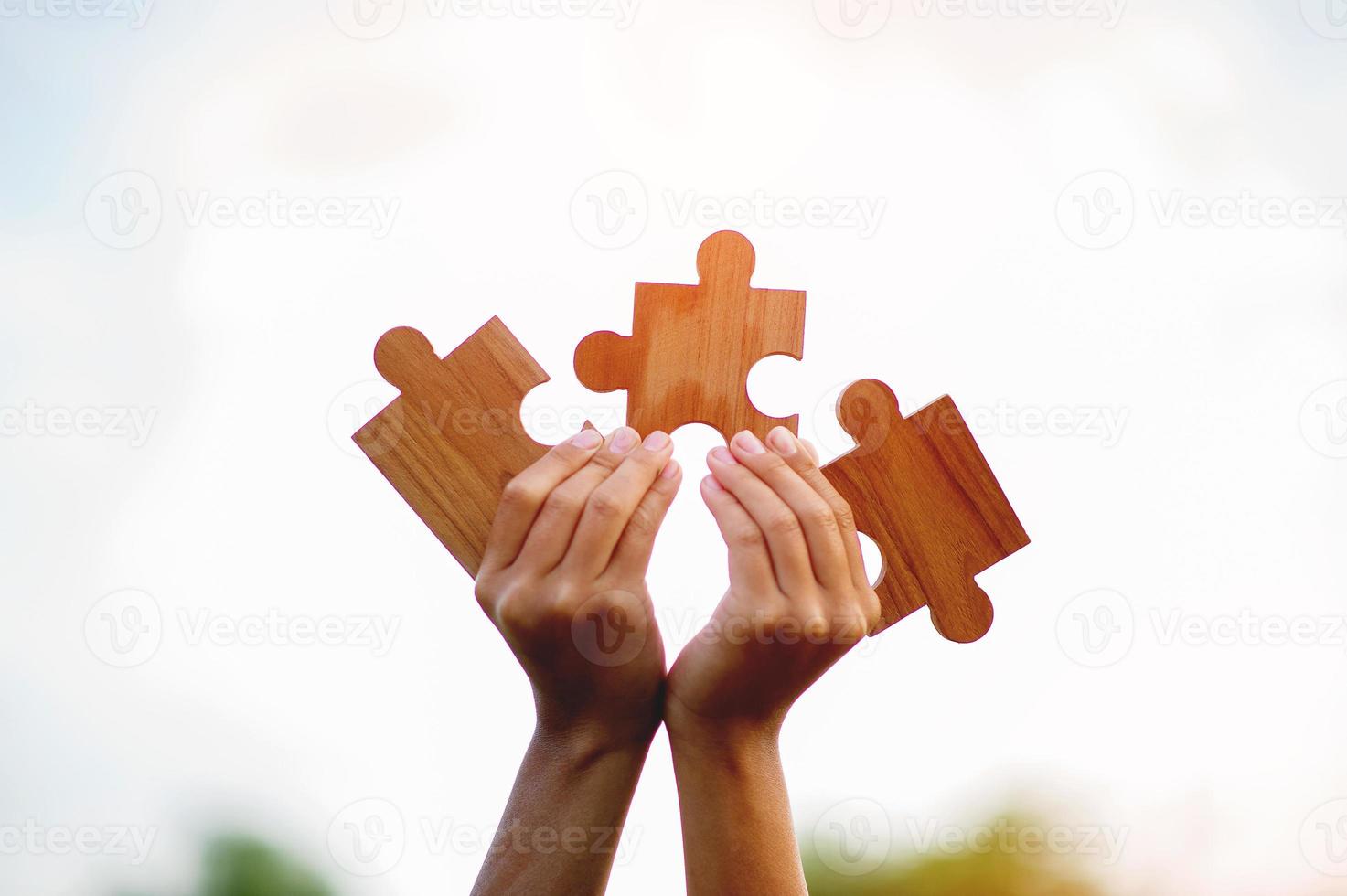 jigsaw and hands Combine the power of unity, teamwork, teamwork. photo