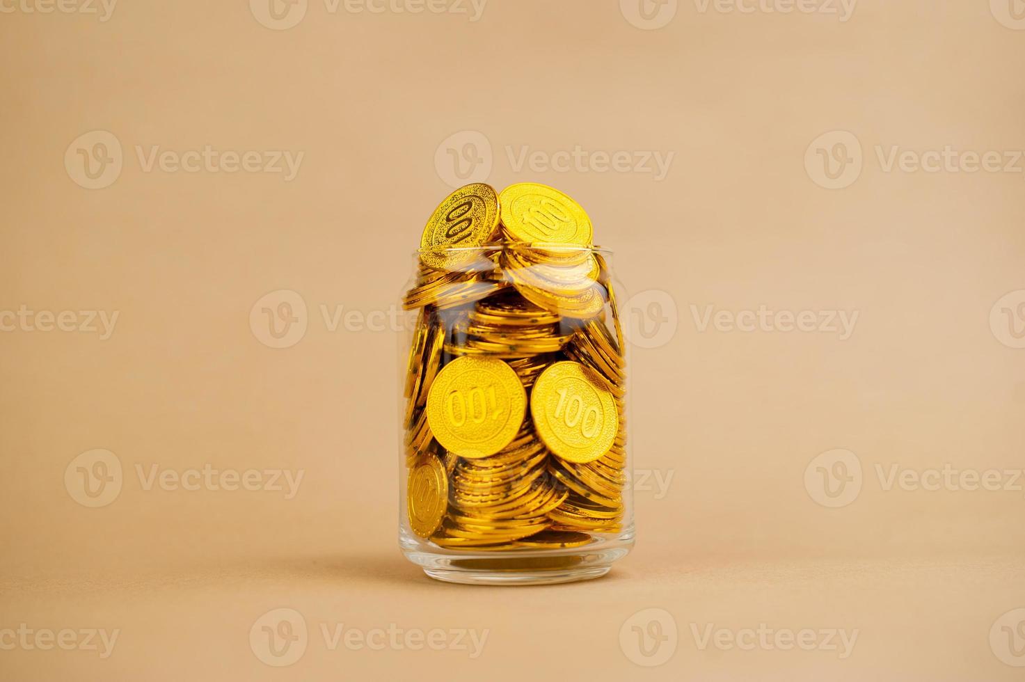 Gold Coins Save gold coins in glass jars. Concept photo