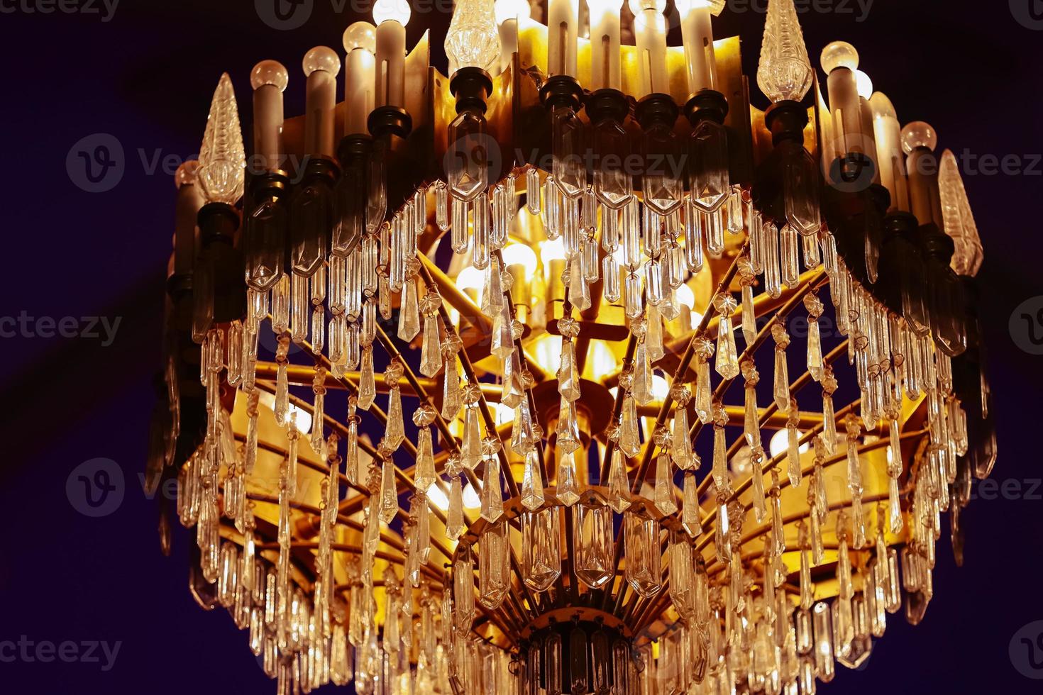 Elegant luxury crystal chandelier on ceiling, beautiful chandelier. Emphasis on luxury, used in various places such as palace church, residence..Decorative elegant vintage and Contemporary Concept. photo