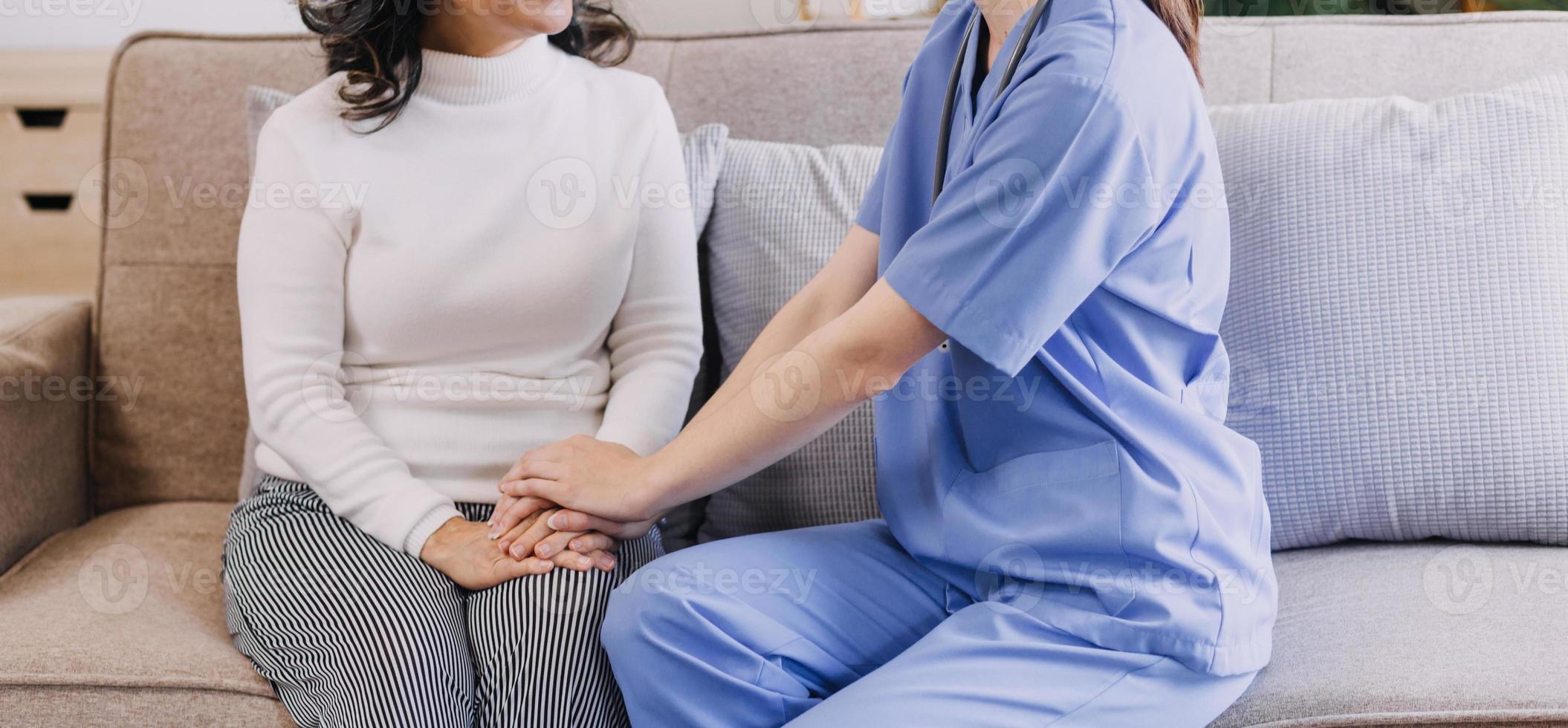 Homecare nursing service and elderly people cardiology healthcare. Close up of young hispanic female doctor nurse check mature caucasian man patient heartbeat using stethoscope during visit photo