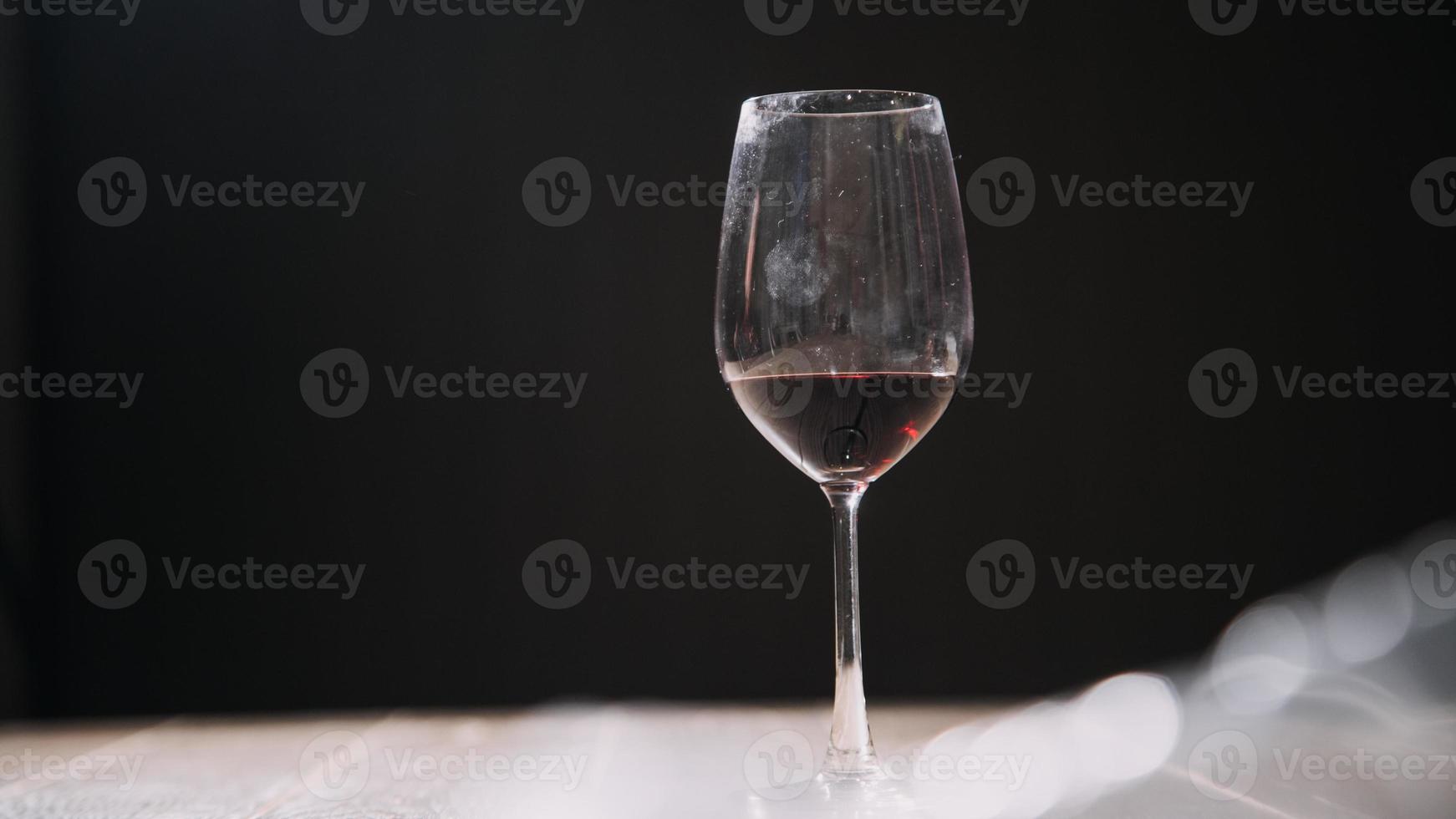 Set of hands holding red wine glass isolated on black background. photo