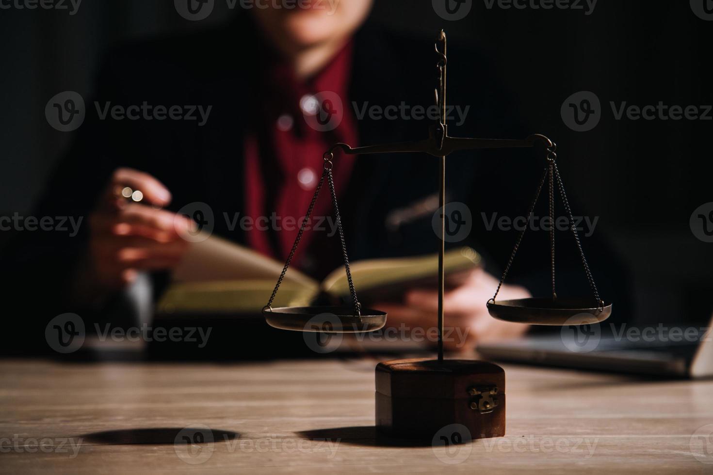 Justice and law concept.Male judge in a courtroom with the gavel, working with, computer and docking keyboard, eyeglasses, on table in morning light photo