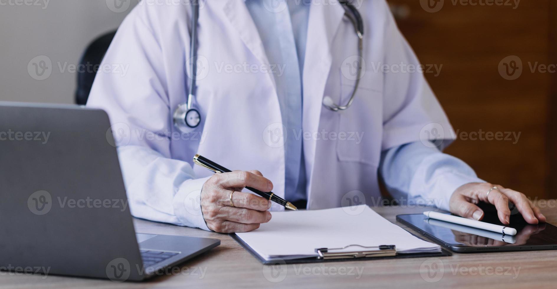 Homecare nursing service and elderly people cardiology healthcare. Close up of young hispanic female doctor nurse check mature caucasian man patient heartbeat using stethoscope during visit photo