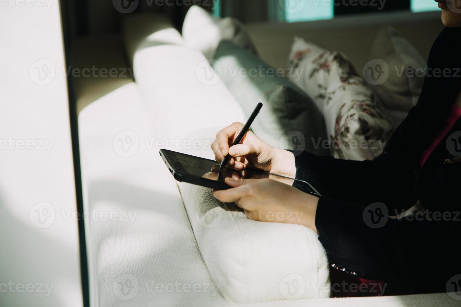 Mature businessman using a digital tablet to discuss information with a younger colleague in a modern business lounge photo