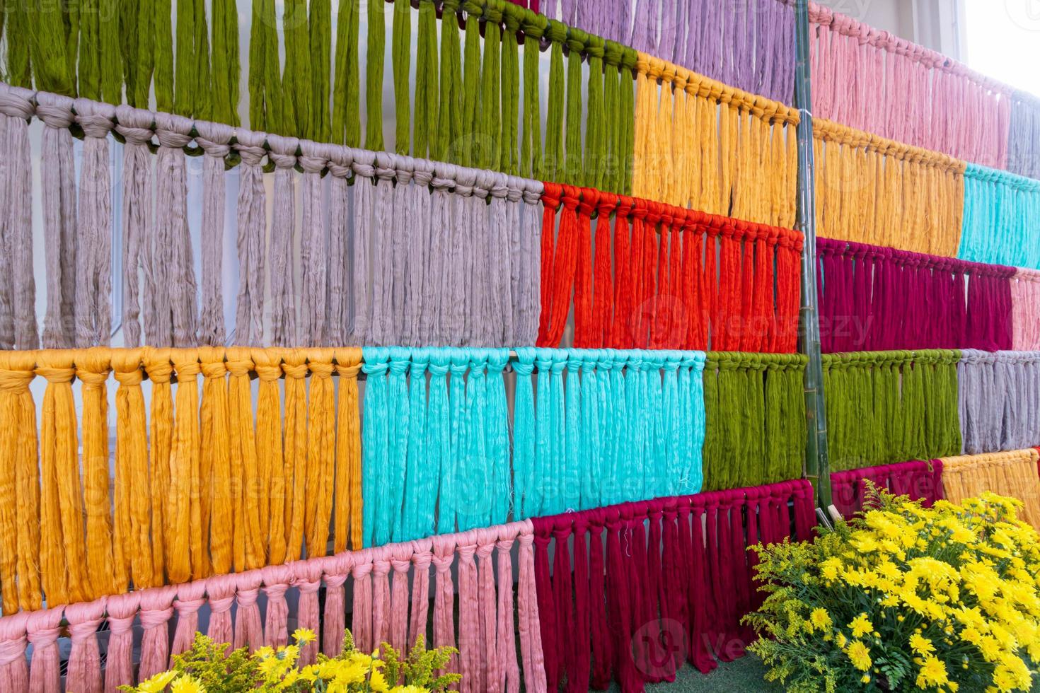 Many of the threads that are dyed brightly are the ones that have been prepared for the traditional loom because the fabric woven on the traditional loom is handmade and expensive. photo