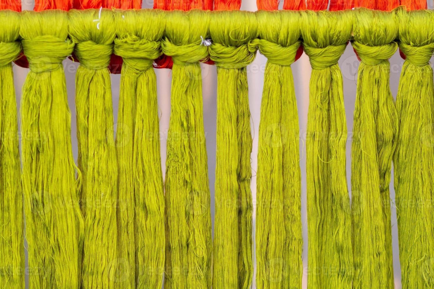 Many of the threads that are dyed brightly are the ones that have been prepared for the traditional loom because the fabric woven on the traditional loom is handmade and expensive. photo