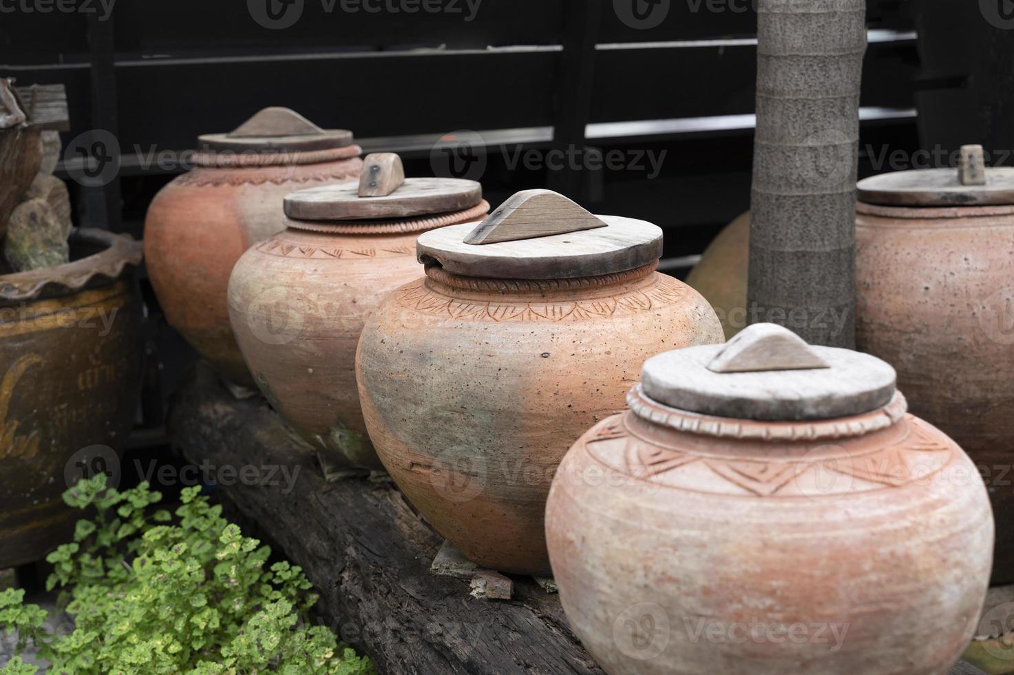 symbol of several jars with wooden lids on top photo