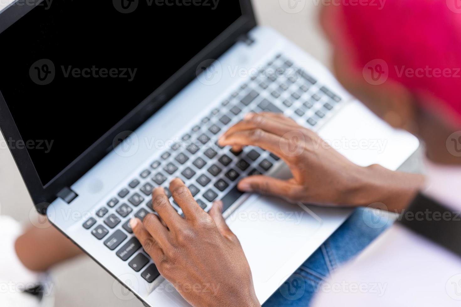 Top view of hands of a woman using a laptop photo