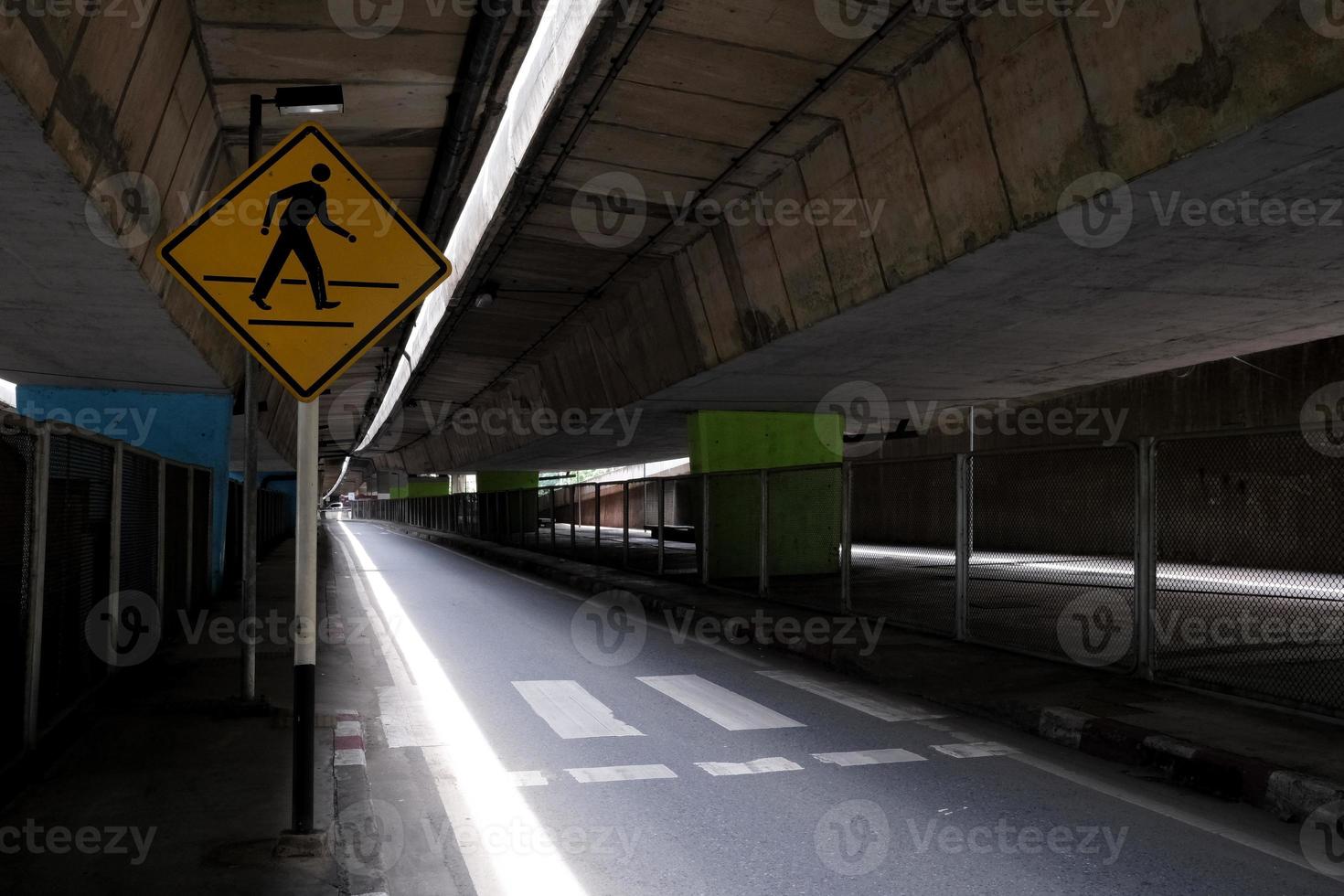 Crosswalk and Sign under Overpass. photo