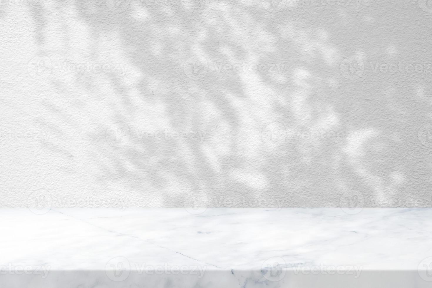 White Marble Table with Tree Shadow in the Garden on Concrete Wall Texture Background, Suitable for Product Presentation Backdrop, Display, and Mock up. photo
