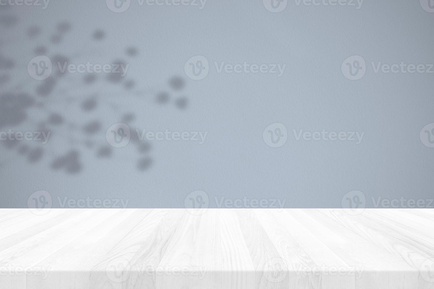 Wood Table with Flower Shadow on Stucco Wall Texture Background in Cerulean Tone, Suitable for Product Presentation Backdrop, Display, and Mock up. photo