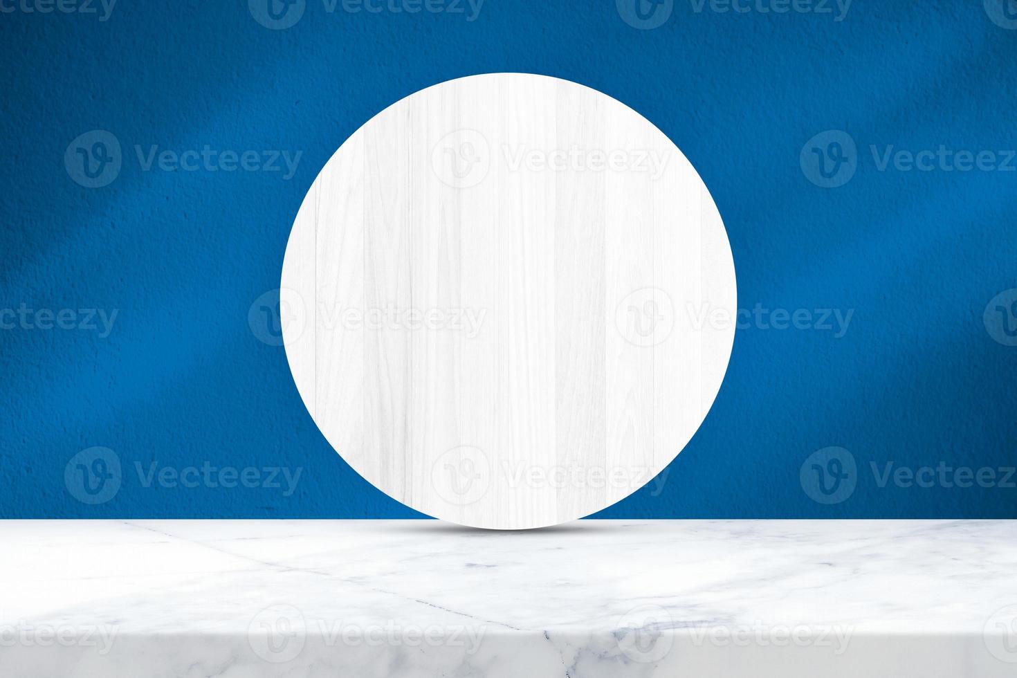 White Marble Table and Circle Wood Partition with Light Beam and Shadow on French Blue Concrete Wall Texture Background, Suitable for Cosmetic Product Presentation Backdrop, Display, and Mock up. photo