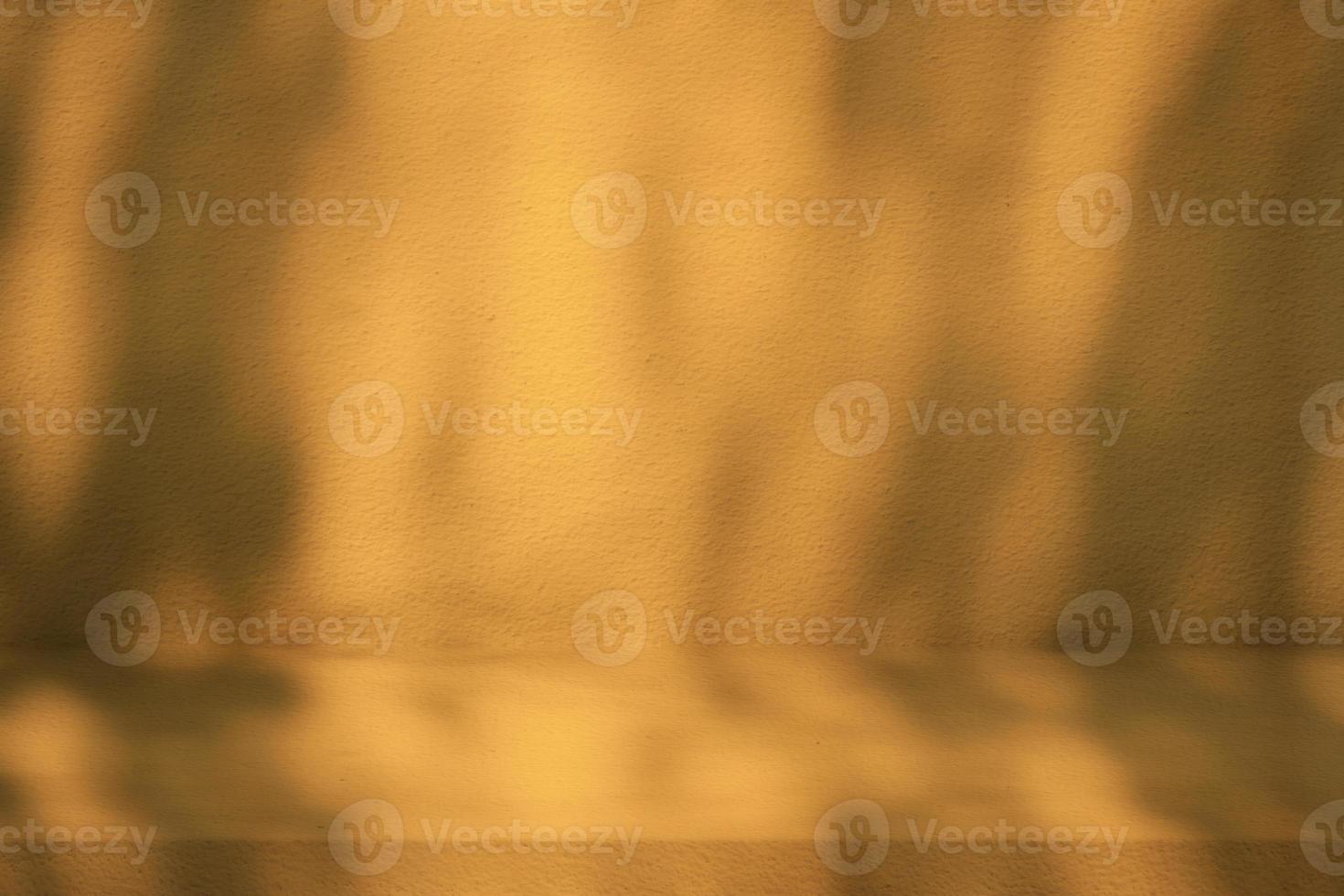Marigold Color Stucco Table with Nature Shadow on Concrete Wall Texture Background, Suitable for Cosmetic Product Presentation Backdrop, Display, and Mock up. photo