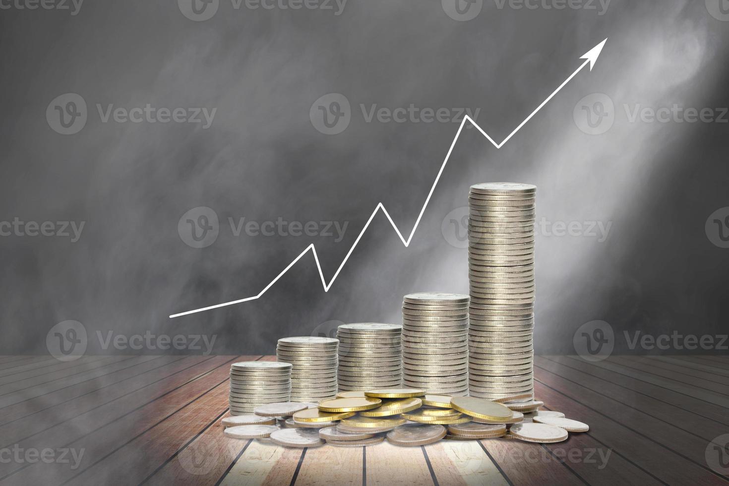 coins stack with lighting and smoke on wooden stage and chart of indicators photo