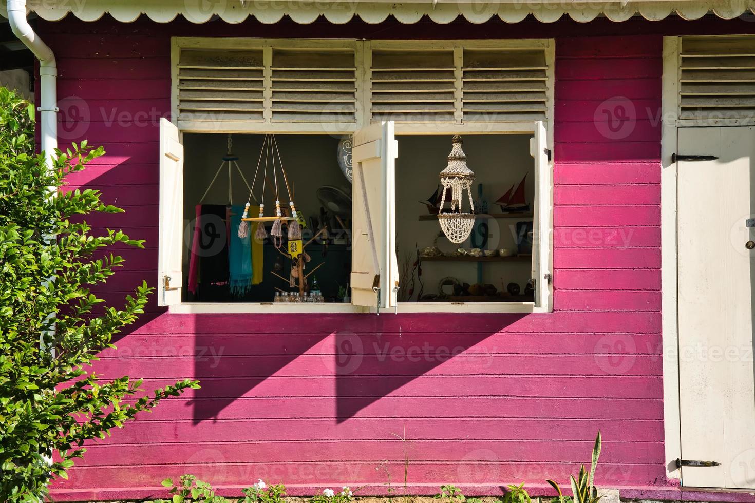 window with shutters of craft village house, a souvenir shop photo