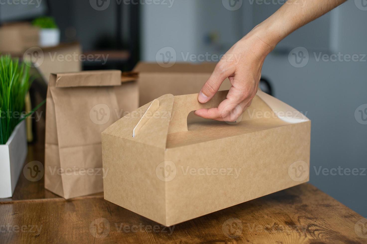 Craft food box with a handle in a person's hand photo