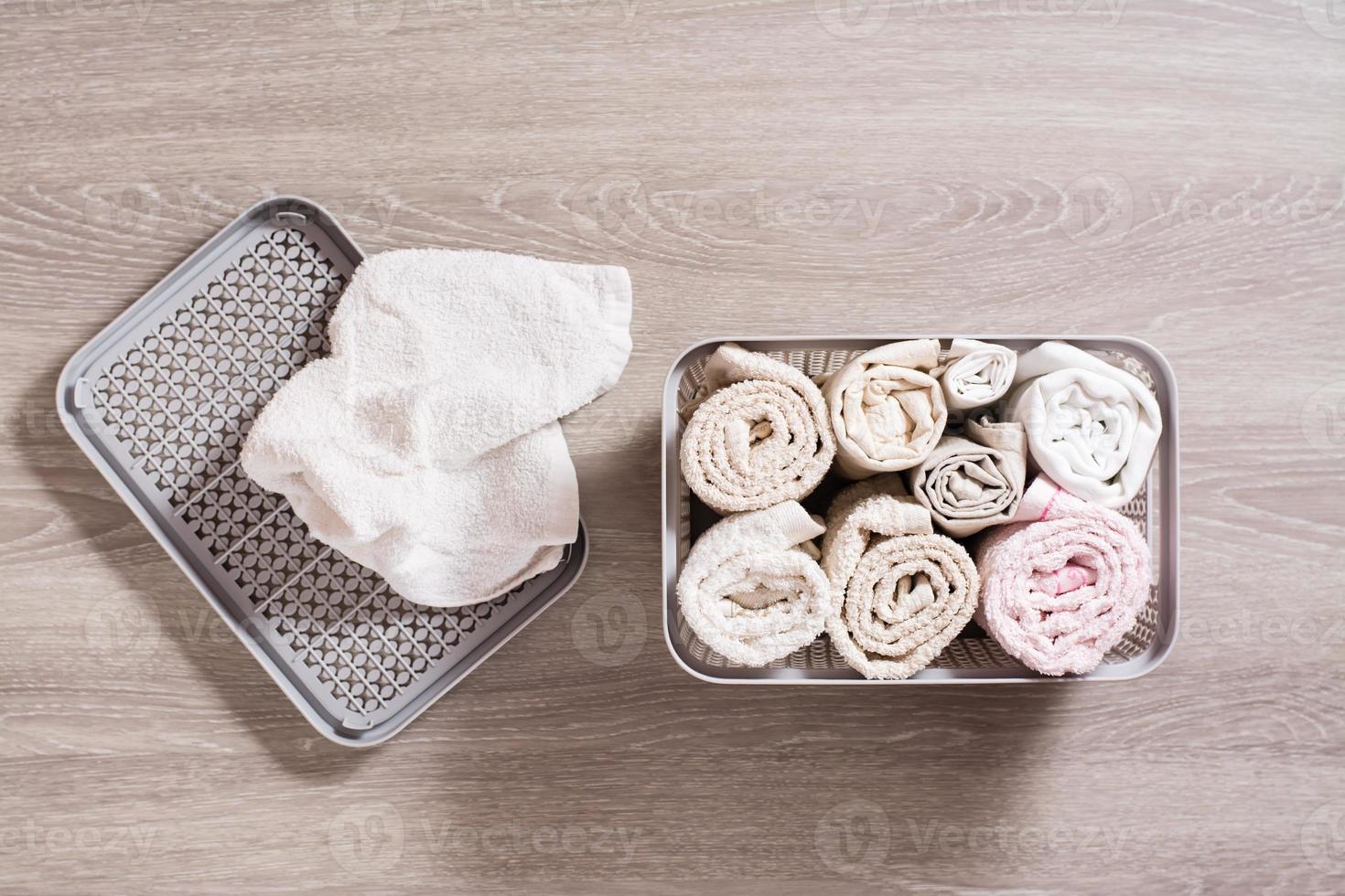 Neatly folded towels in a clothes drawer. Organization and order at home. Top view. photo