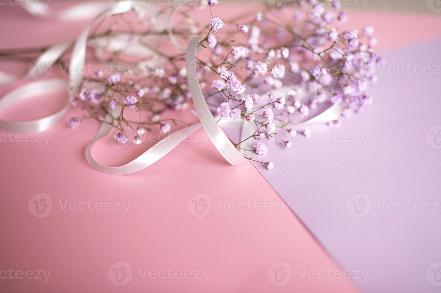 Pink tablet for text with a background of white flowers and ribbon photo