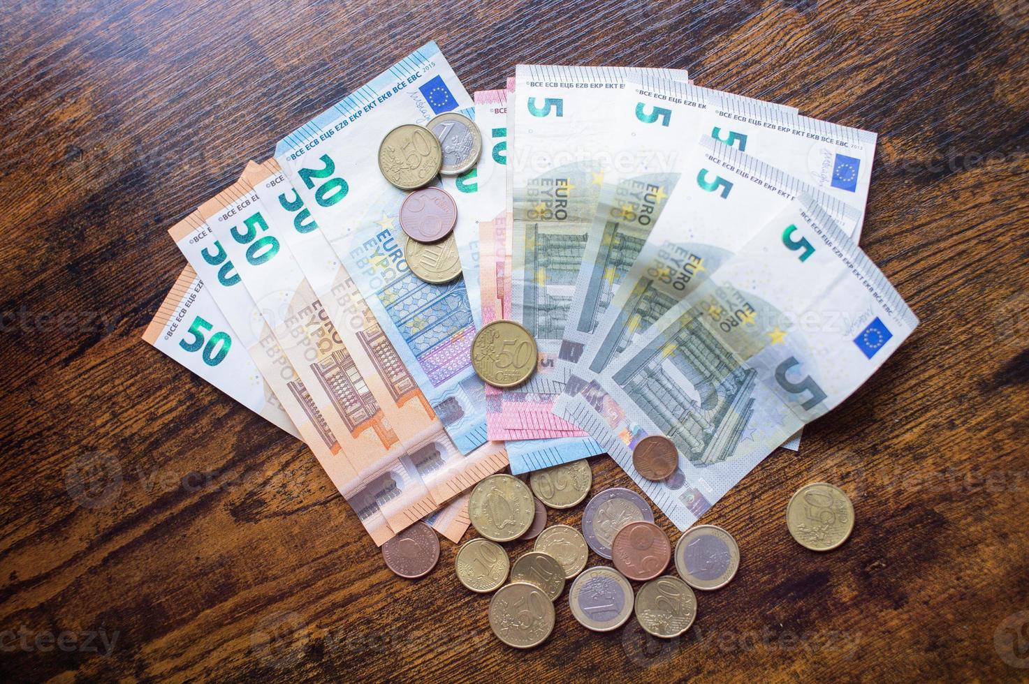 Euro banknotes and coins are on the table photo