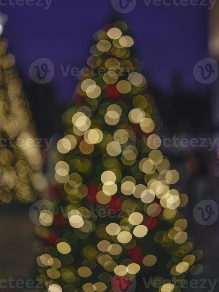 Blur light celebration on christmas tree with bokeh background photo
