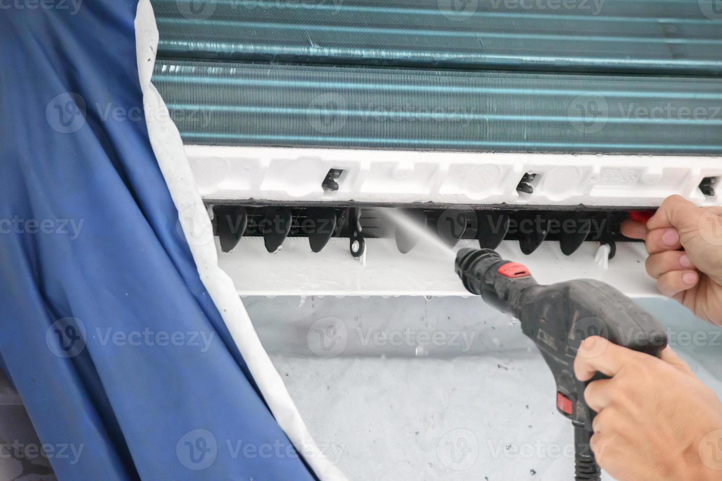 air conditioning cleaning service with water spray photo