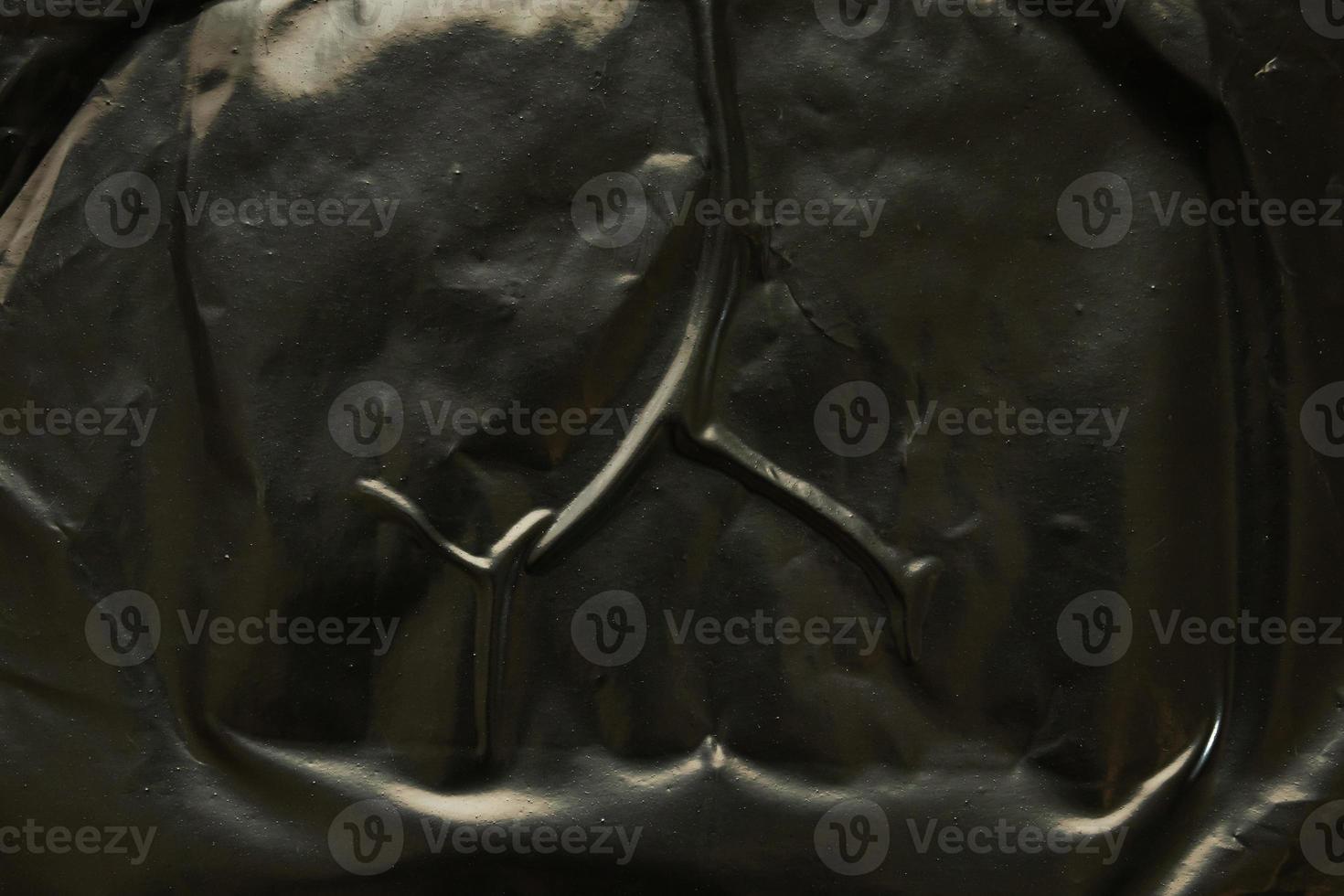 black crumpled and creased plastic poster texture background photo