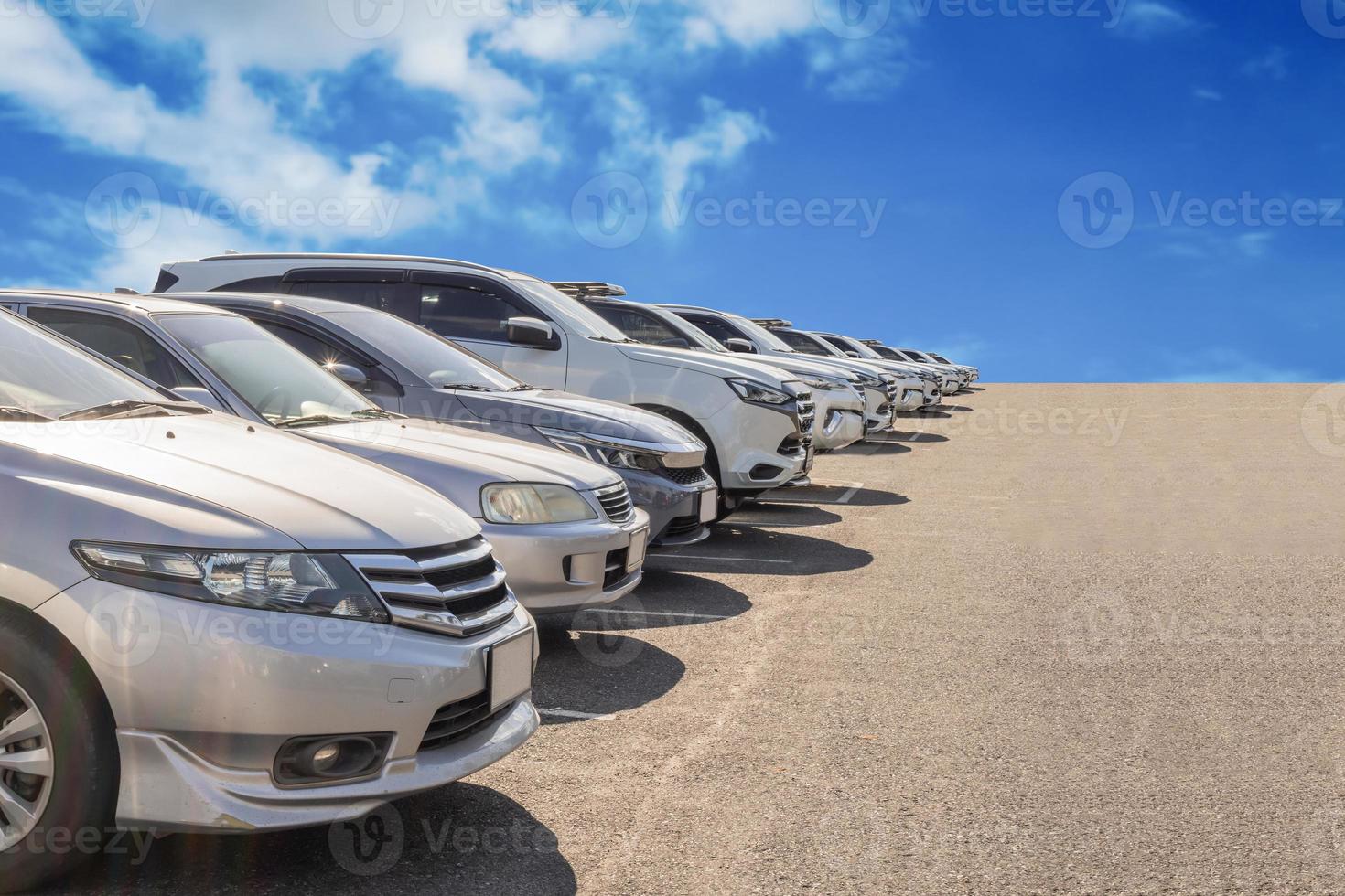 Lot of used car for sales in stock with sky and clouds photo