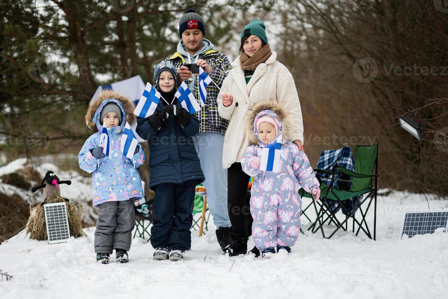 Finnish family with Finland flags on a nice winter day. Nordic Scandinavian people. photo