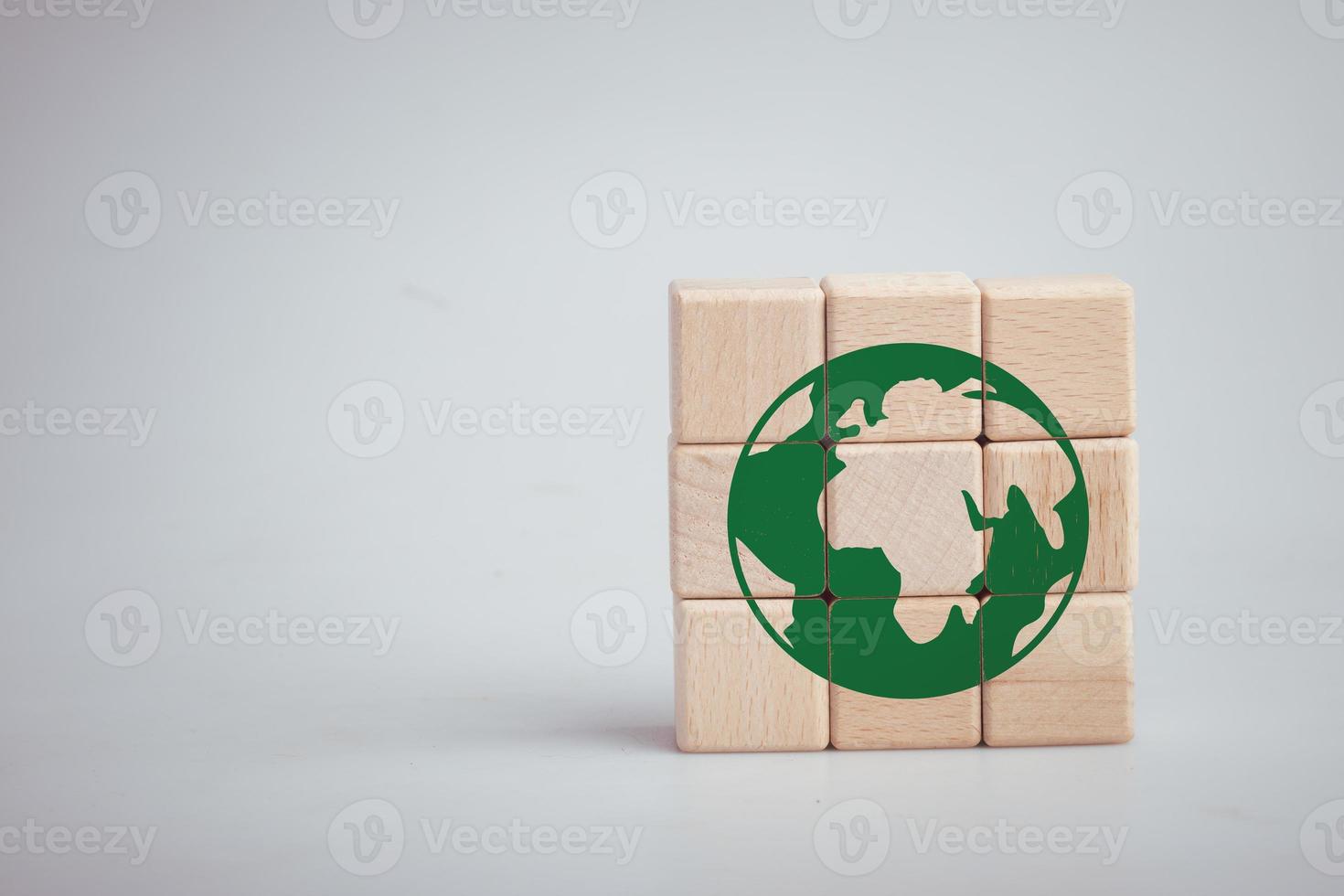 Wooden block with green earth icon. Green earth love concept. photo